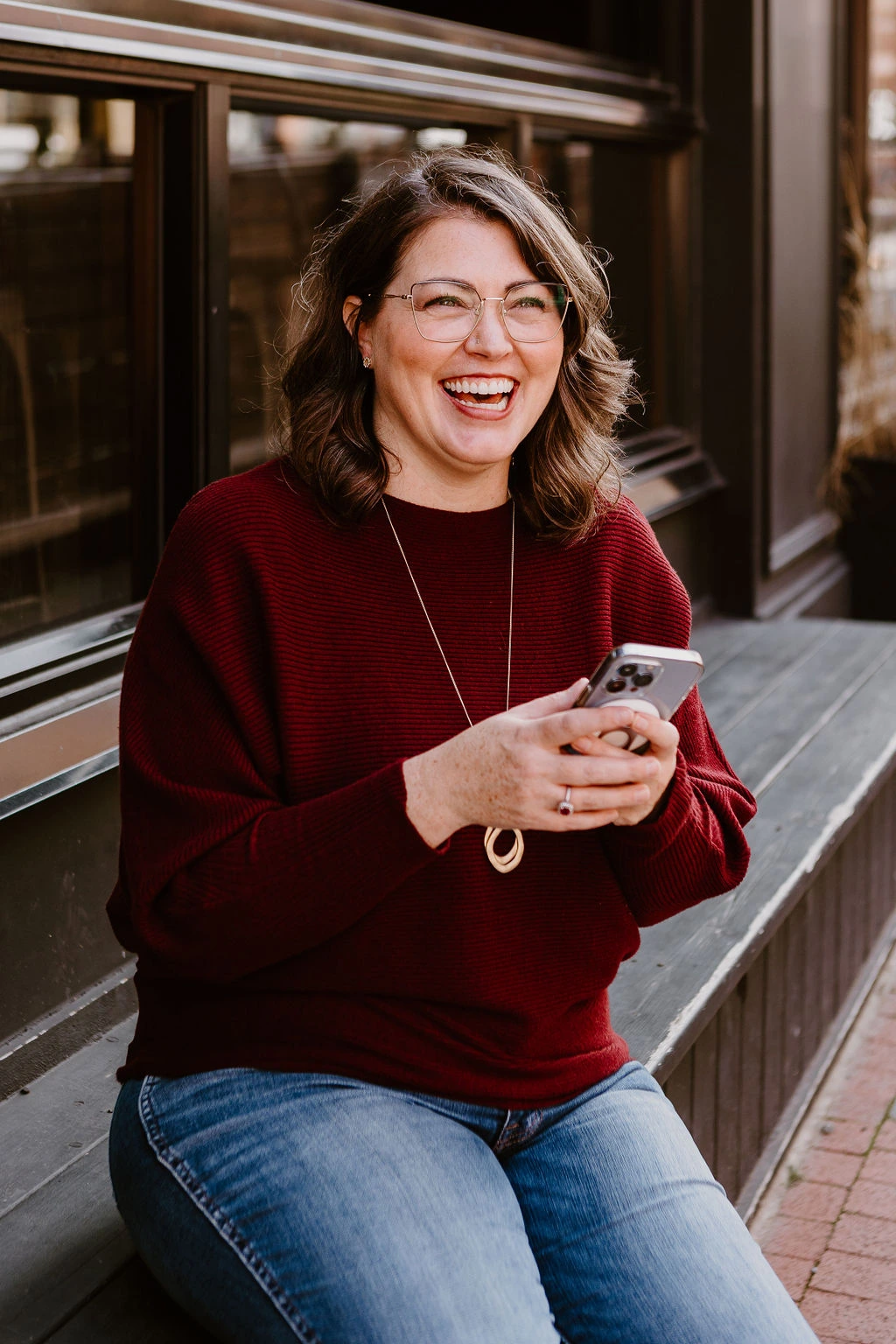 Erica Waddell, founder of Post Road Marketing, laughing outdoors in Saint John NB