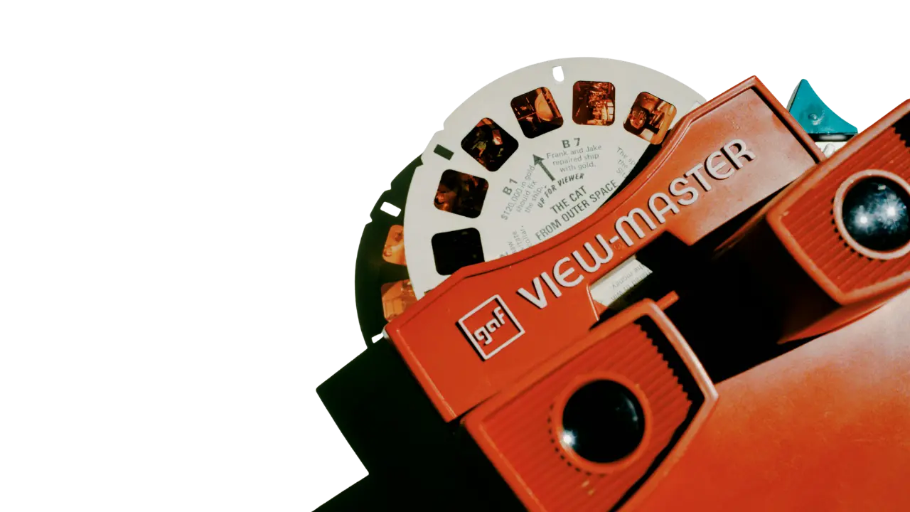 A vintage GAF View-Master toy with a film reel loaded, shot against a black background