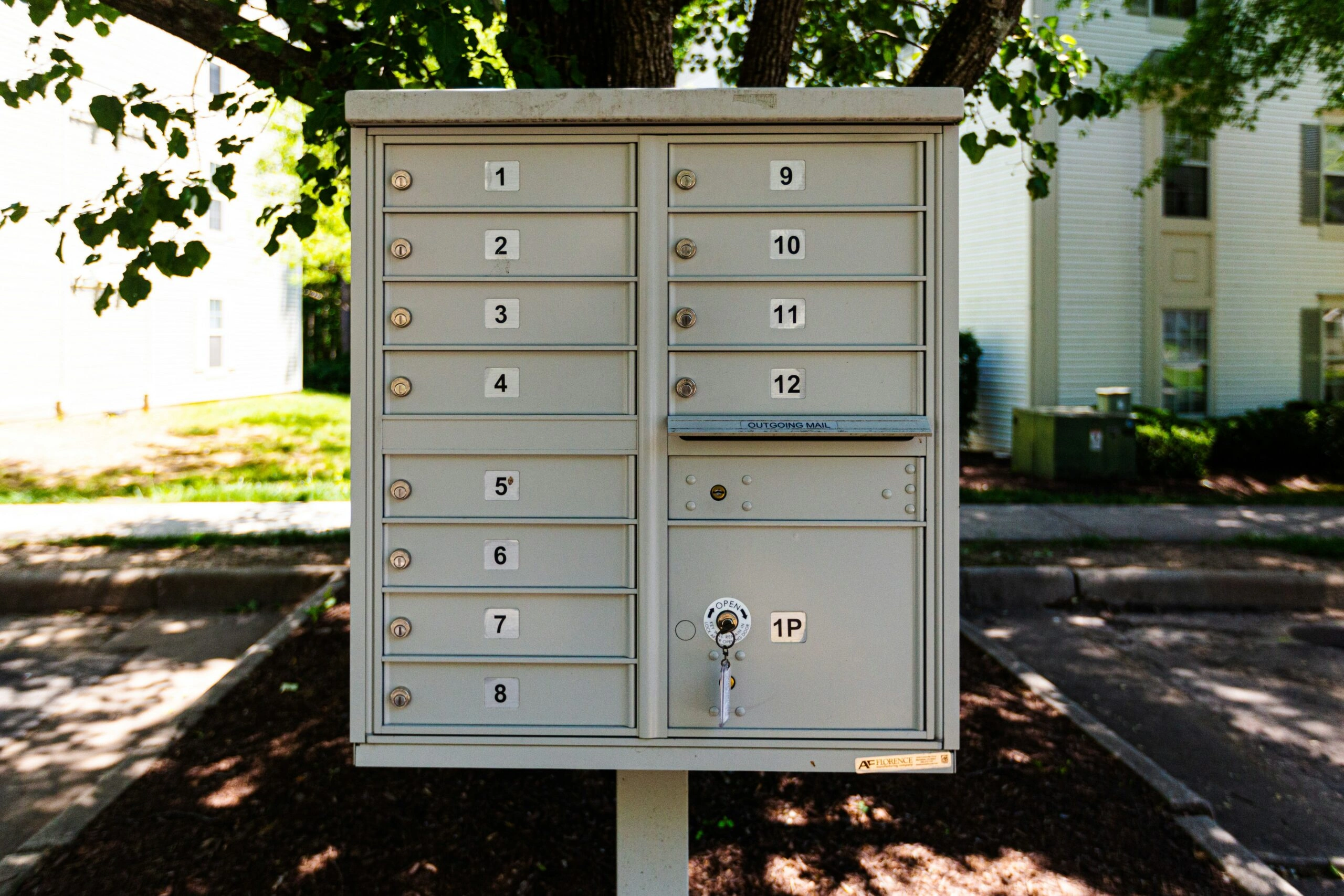 Numbered community mailbox cluster on a sunny residential street