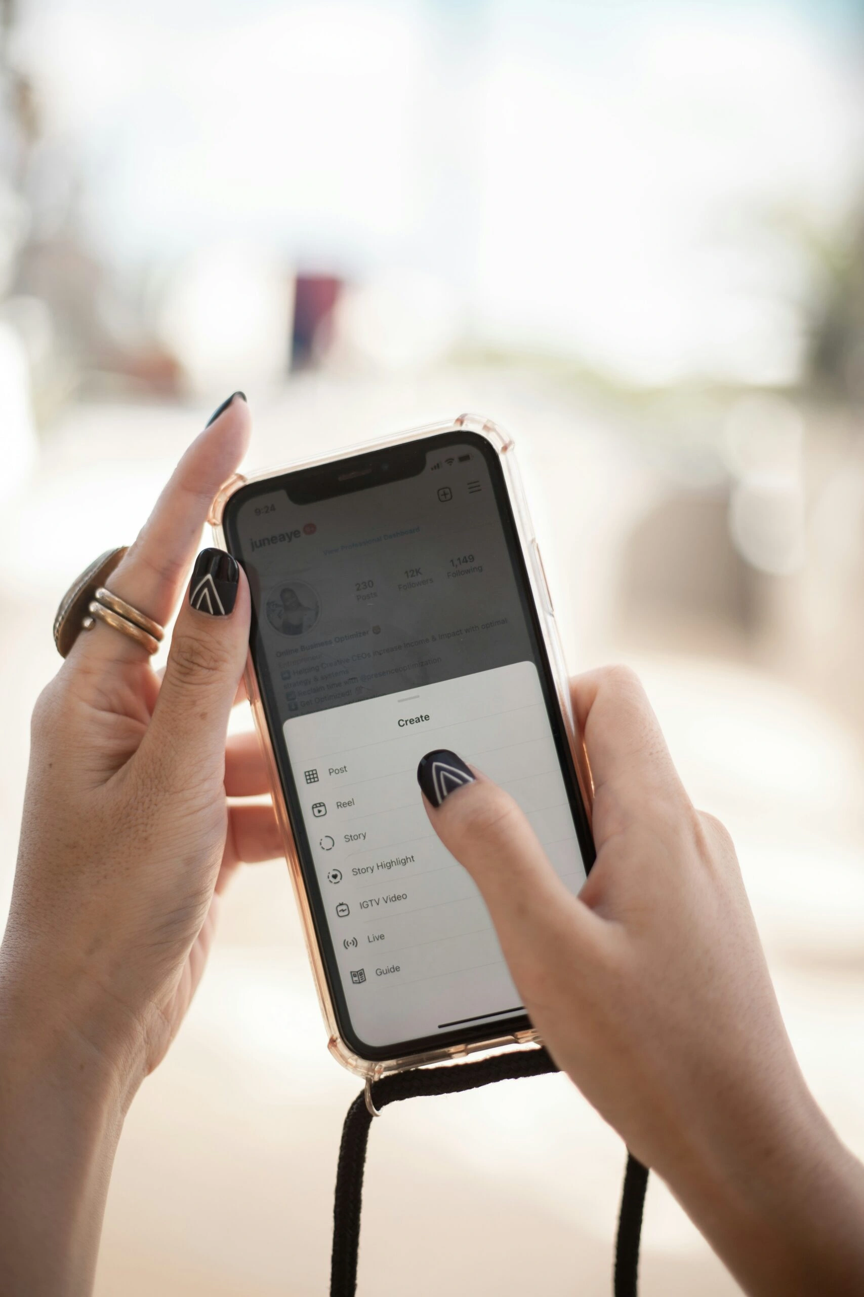 Hands holding a phone open to the Instagram create menu with Reel option visible