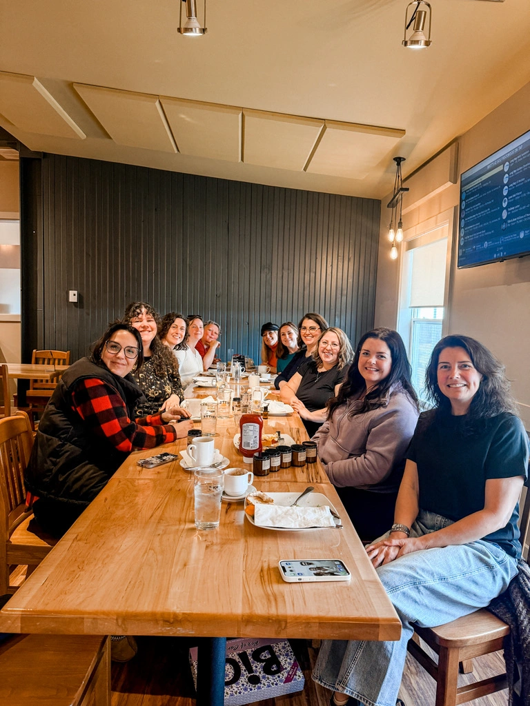Women business owners gathered around a long table at a Roundabout monthly meetup in Saint John, New Brunswick