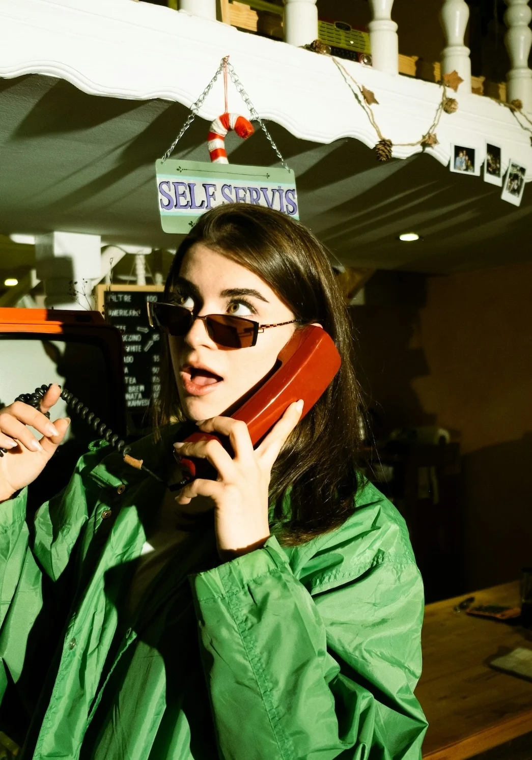 Woman on a retro phone in a café — used to illustrate the idea of a custom GPT that already knows your business