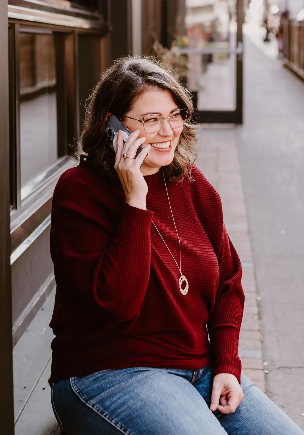 Erica Waddell on a phone call on a sidewalk in downtown Saint John, New Brunswick
